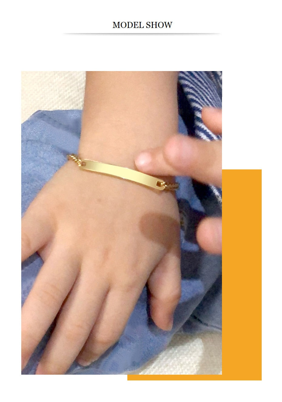 Gold-tone stainless steel personalized baby name bracelet with adjustable fit, featuring custom engraved name, by The Clothing Company Sydney.