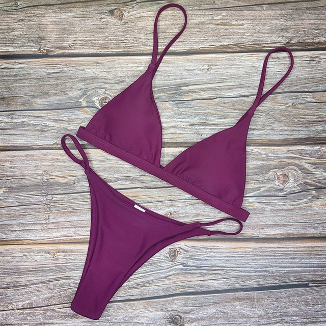 Low-cut two-piece micro bikini in four colors, backless design with push-up support, perfect for beachwear and swimming.