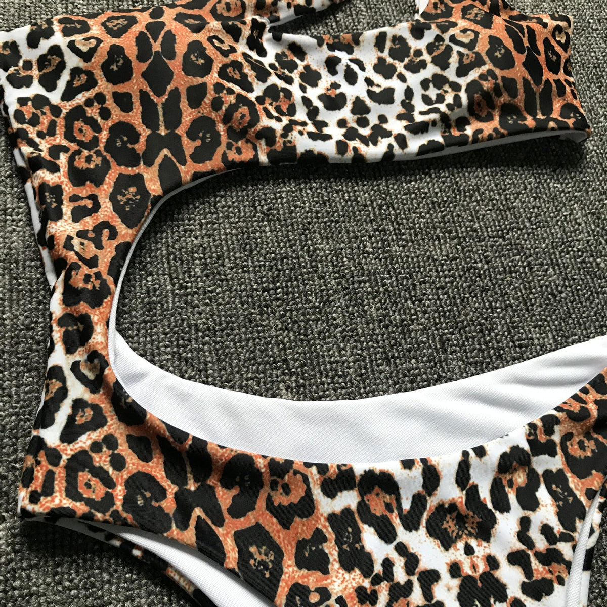 Leopard print one-piece beachwear bikini set with single shoulder strap and midriff design by The Clothing Company Sydney.