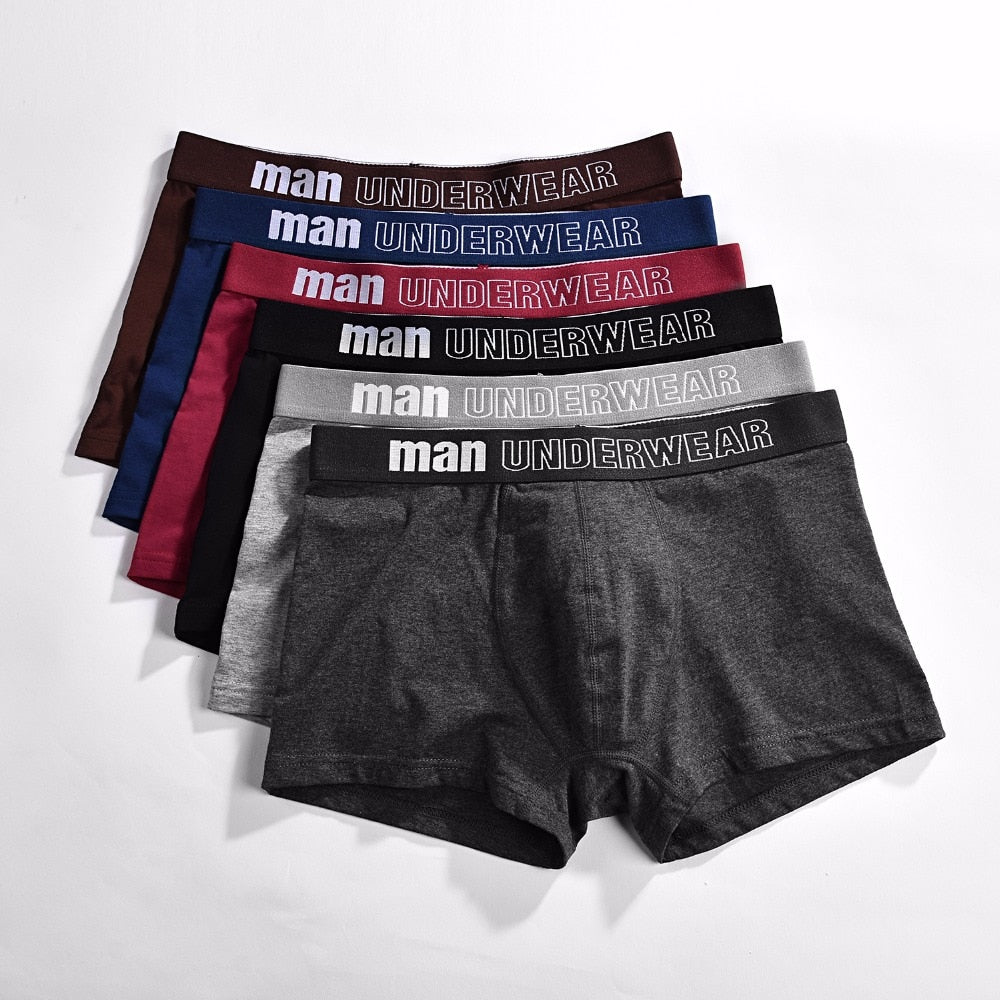 Four men's cotton boxer briefs in solid colors, breathable and flexible, from The Clothing Company Sydney.