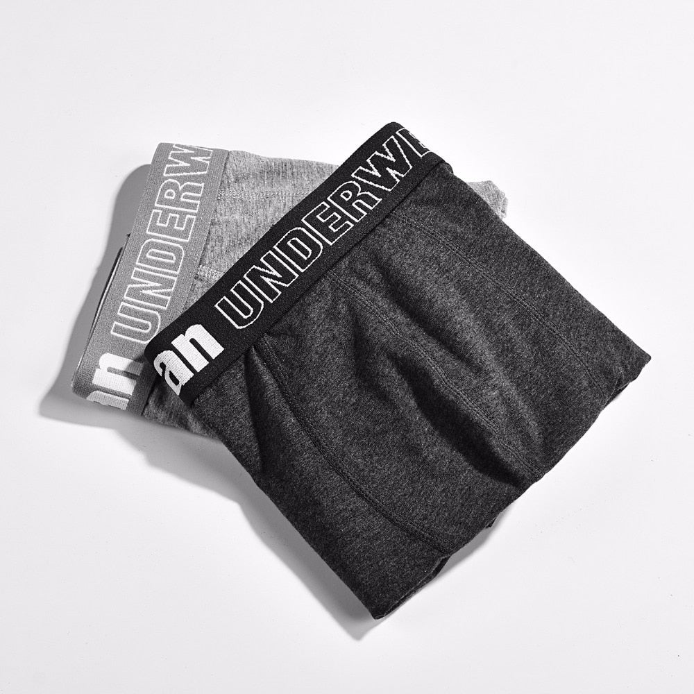Four pairs of men's cotton boxer briefs from The Clothing Company Sydney, breathable solid black and navy trunks with flexible fit.