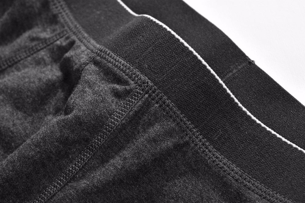 Four pairs of men's cotton boxer briefs from The Clothing Company Sydney, featuring breathable solid colors and a flexible fit.