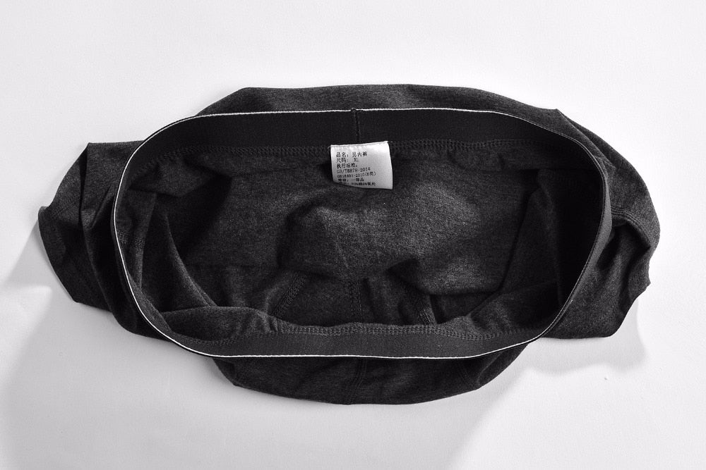 Four pairs of men's cotton boxer briefs from The Clothing Company Sydney, featuring breathable, flexible solid color trunks.