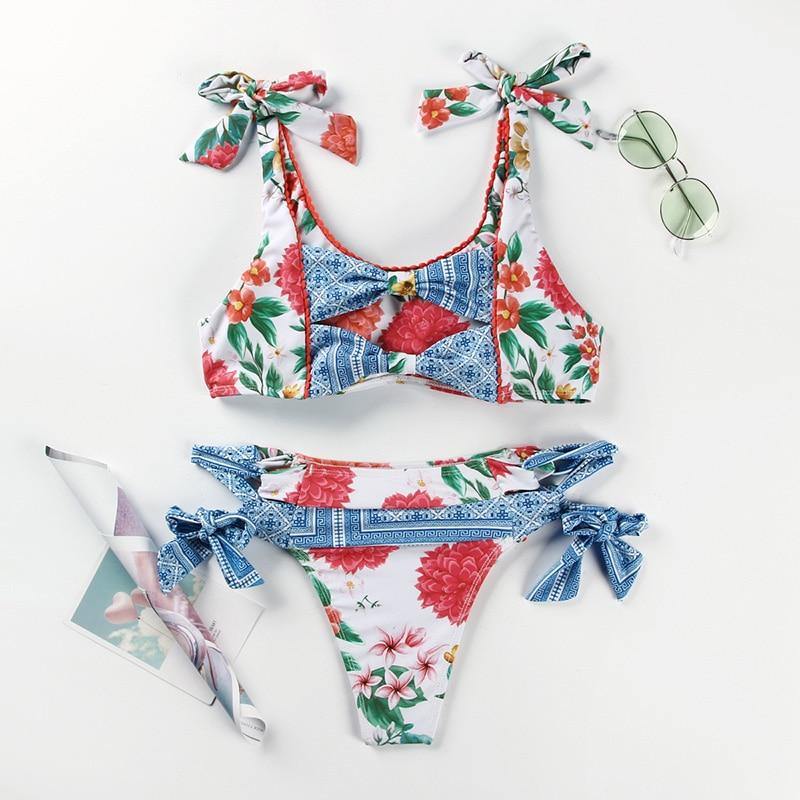 Deep V neck floral print bikini by The Clothing Company Sydney featuring bow detail and lace-up design, perfect for beachwear.