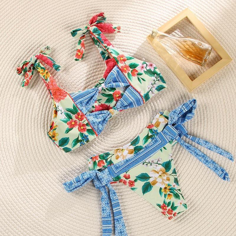Deep V neck floral print bikini swimsuit with bow and lace-up detail, stylish swimwear from The Clothing Company Sydney.