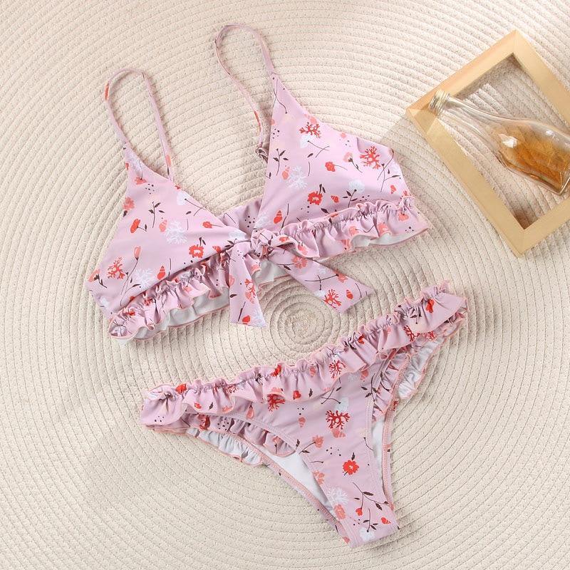Deep V neck floral print bikini from The Clothing Company Sydney featuring bow accents and lace-up design.
