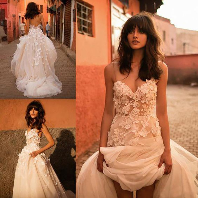Boho princess wedding gown by The Clothing Company Sydney featuring sweetheart neckline, floral appliqués, tulle backless A-line dress