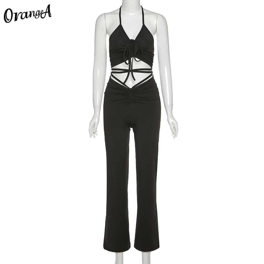 Stretchy beige sweatpants from The Clothing Company Sydney paired with a matching halter bandage v-neck sleeveless ruched top.