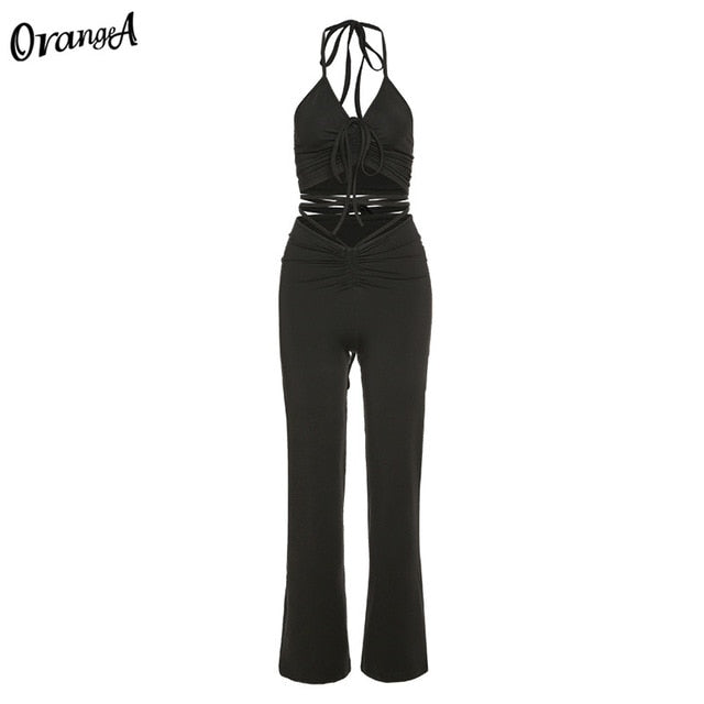 Stretchy black skinny pants from The Clothing Company Sydney, part of a matching halter bandage ruched top and sweatpants clubwear set.