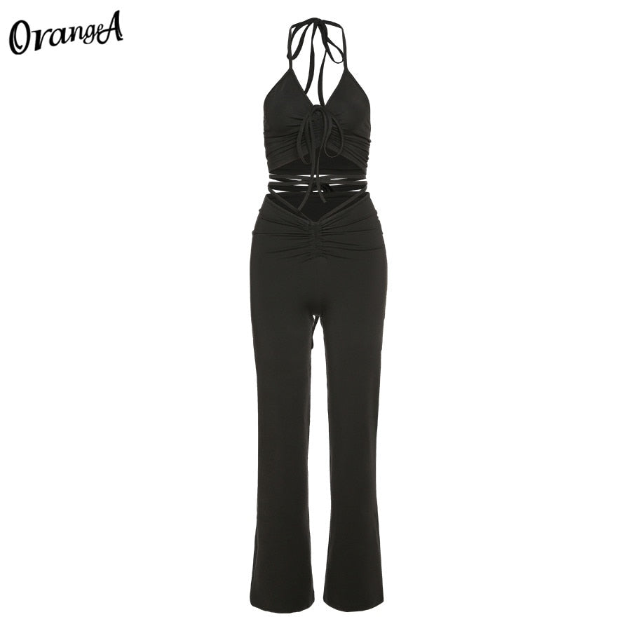 Stretchy black sweatpants from The Clothing Company Sydney, matching with halter bandage v-neck sleeveless tops in a stylish clubwear set.
