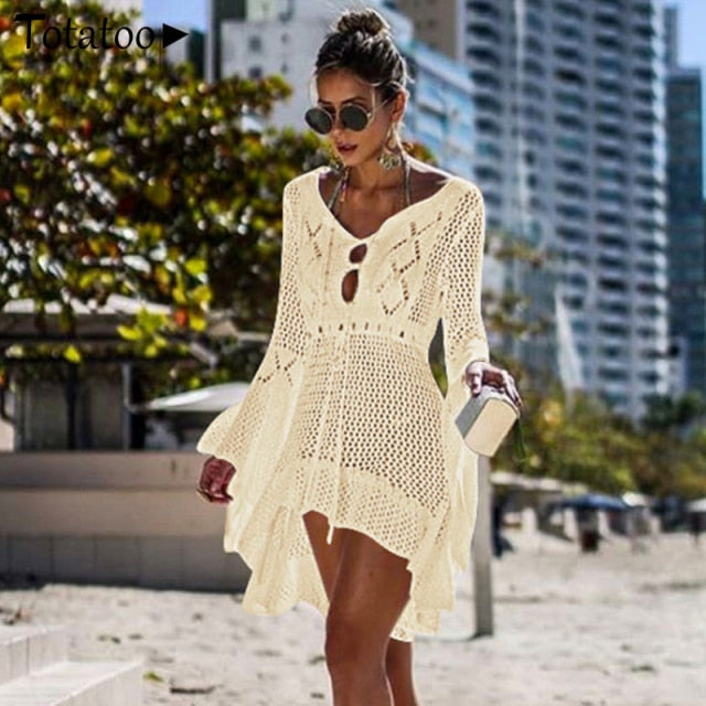 Backless knitted summer long sleeve beach cover mini dress by The Clothing Company Sydney, featuring see-through design and open back.
