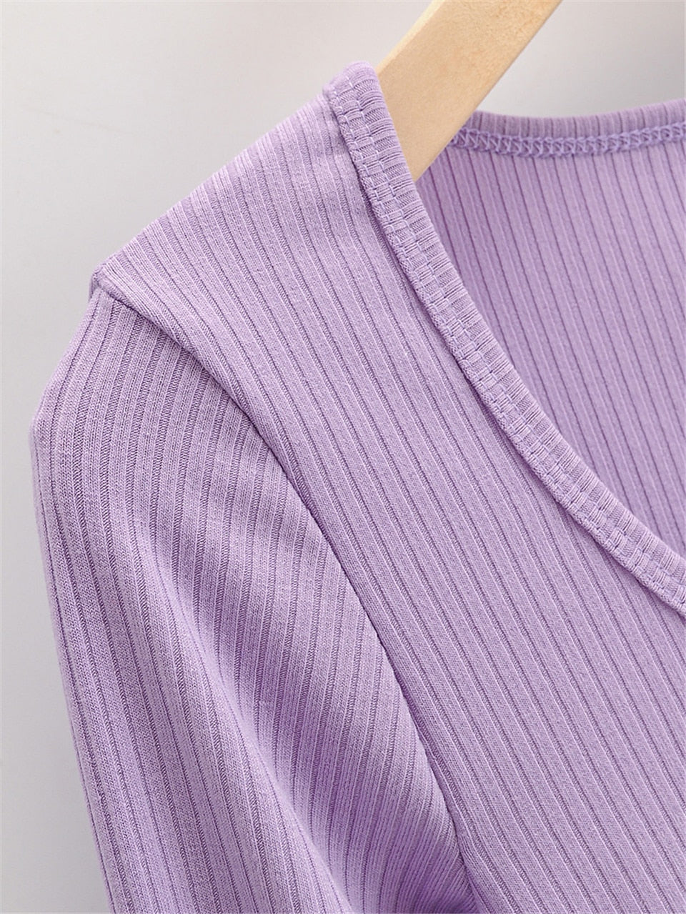 White V-neck long sleeve knitted crop top from The Clothing Company Sydney, featuring slim fit and ribbed texture.