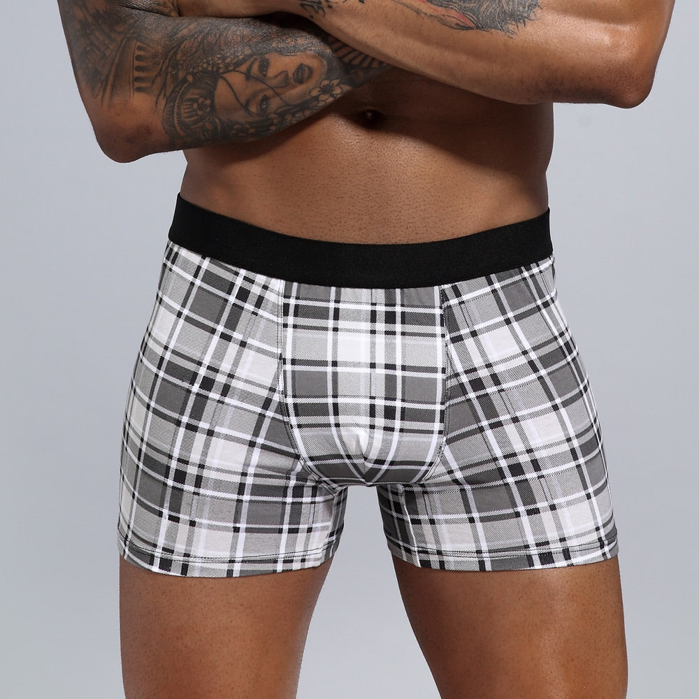 Four men's cotton boxer shorts from The Clothing Company Sydney in a pack, featuring comfortable trunks and briefs.