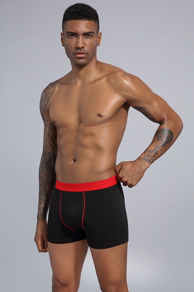 Four men's cotton boxer shorts in a pack, stylish trunks from The Clothing Company Sydney, displayed in a neat arrangement.