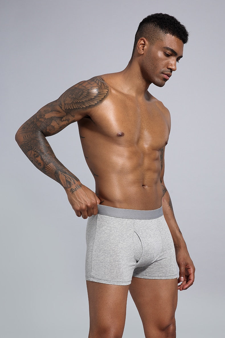 Four men's cotton boxer shorts in a pack from The Clothing Company Sydney, featuring classic trunks design.