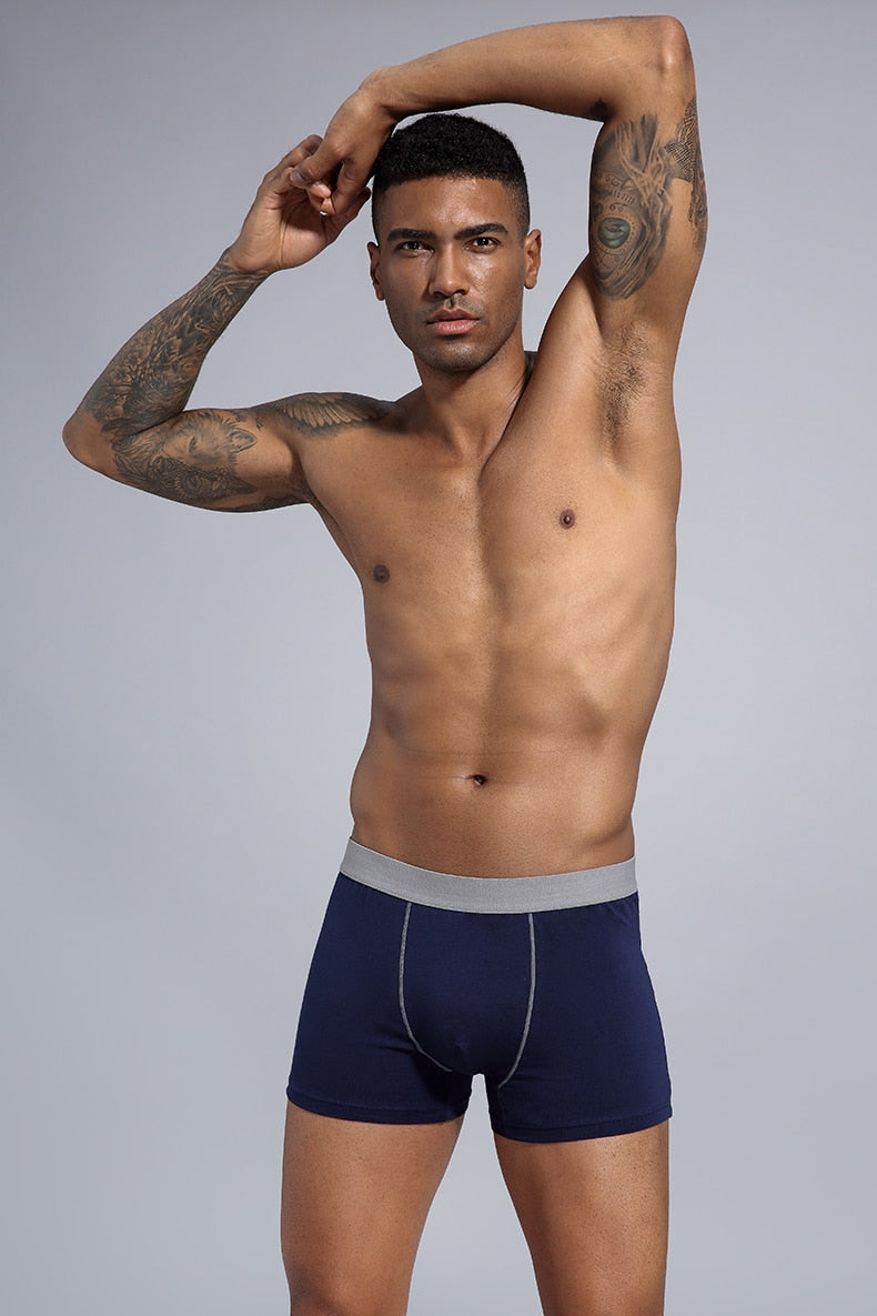 Four men's cotton boxer shorts pack from The Clothing Company Sydney, showcasing comfortable trunks with elastic waistbands.