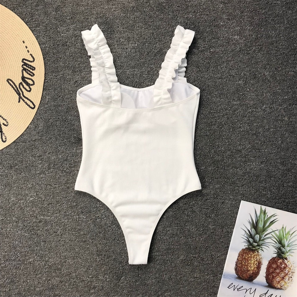 Vintage one-piece swimsuit by The Clothing Company Sydney featuring ruffled design, push-up padding, and solid color.