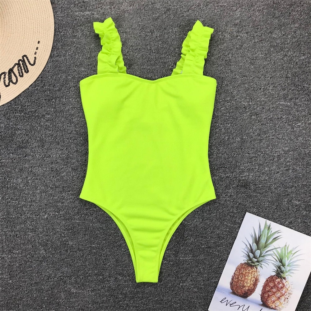 Vintage one-piece ruffled swimsuit by The Clothing Company Sydney featuring push-up padding and solid design with a monokini style.
