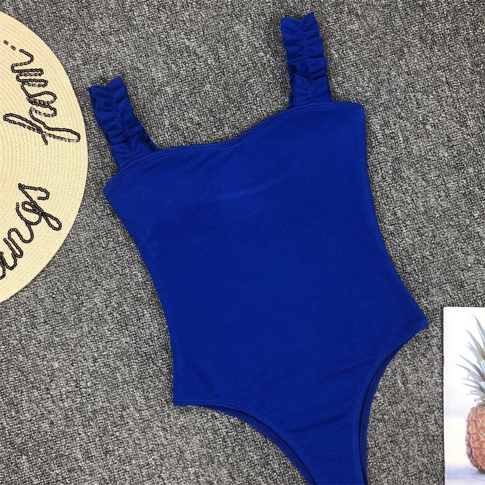 Vintage one-piece ruffled swimwear by The Clothing Company Sydney featuring push-up padding and solid design for stylish swimming.
