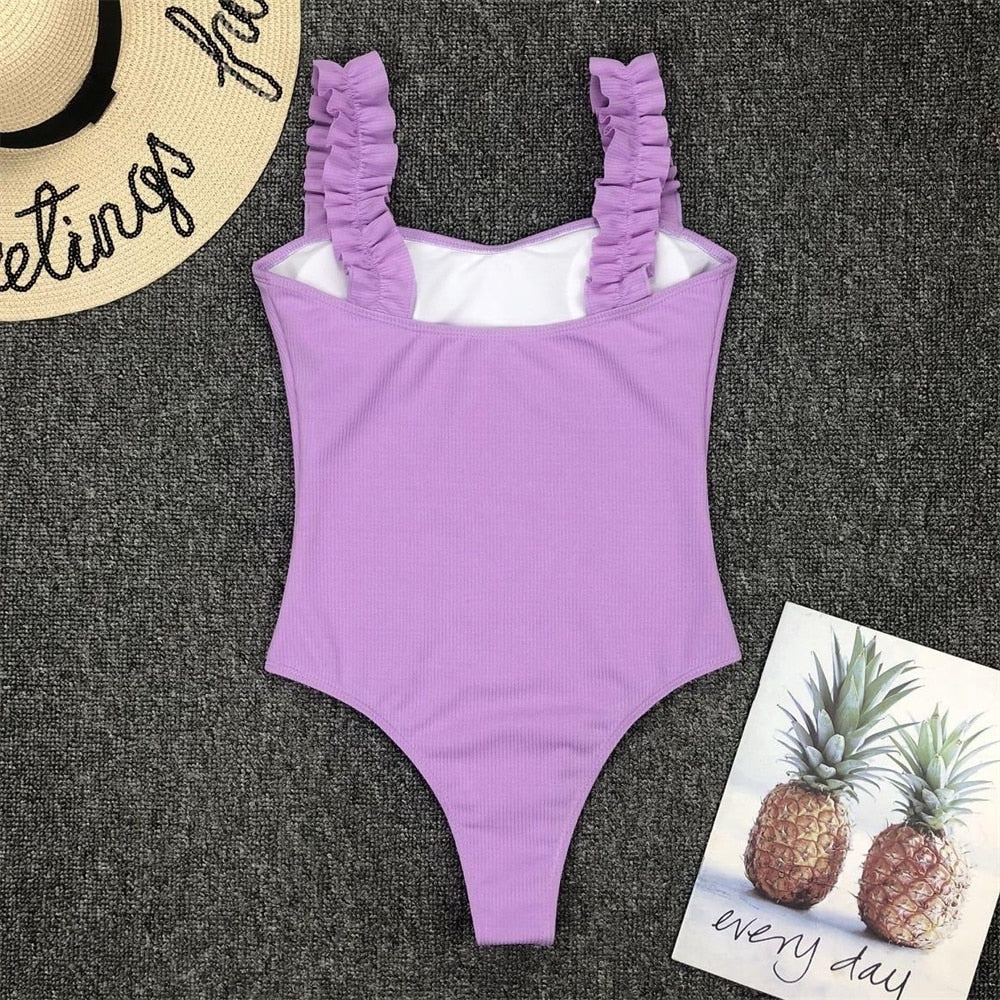 Vintage one-piece ruffled swimsuit by The Clothing Company Sydney, featuring padded bust, solid color, and flattering bikini style.