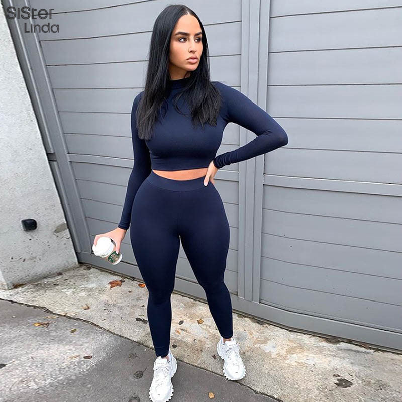Two-piece sporty activewear set with long sleeve tops and matching leggings, designed for fitness and workout routines.