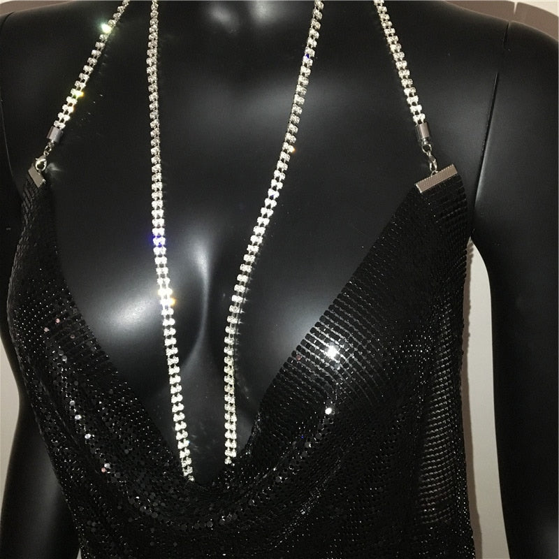 Deep V neck halter sequined dress for women with backless design, rhinestone chain details, suitable for party or metal fashion.