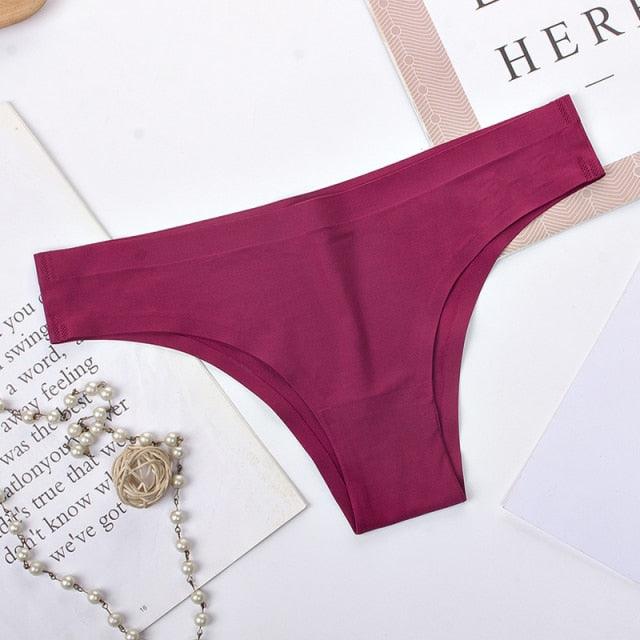 Two pairs of seamless, low-rise women's bikini briefs in ice silk, solid colors, with T-back design, by The Clothing Company Sydney.