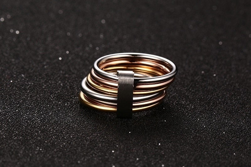 Stacked wide statement cocktail rings with interlocked plain bands in three colors, designed for women by The Clothing Company Sydney.