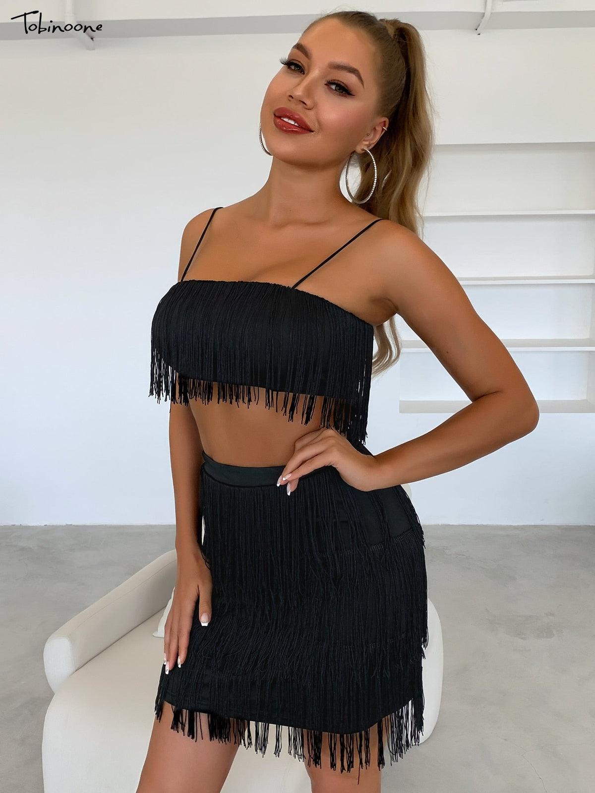 Elegant off-shoulder mini dress with tassel embellishments and fringe details, perfect for summer parties by The Clothing Company Sydney.
