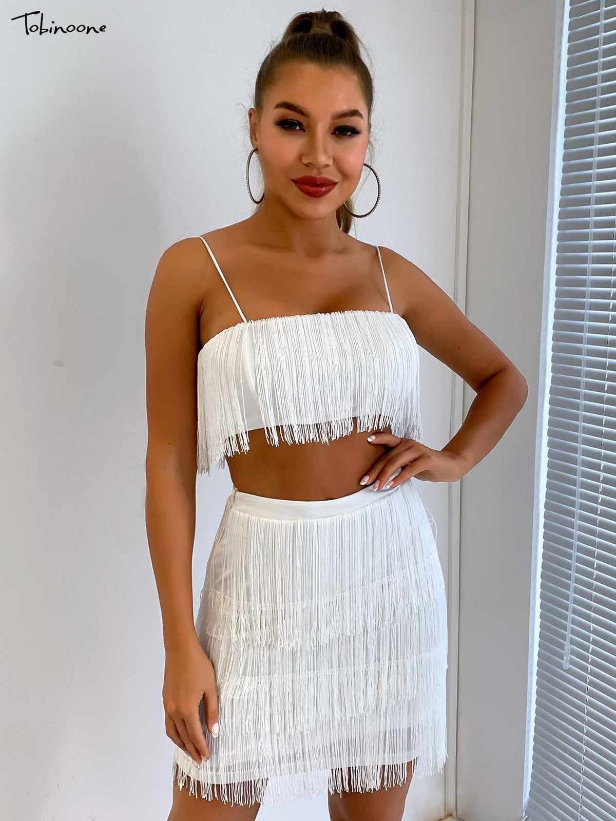 Elegant off-shoulder mini dress with tassel embellishments by The Clothing Company Sydney, perfect for summer parties and clubs.