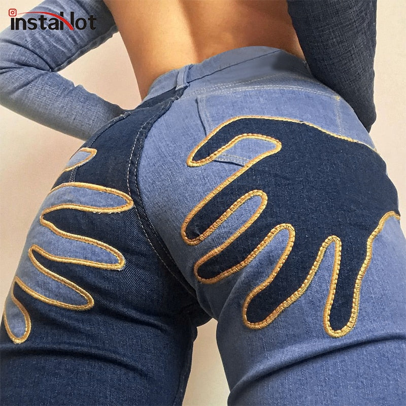Vintage flare jeans by The Clothing Company Sydney featuring embroidery, patchwork details, and a casual streetwear denim style.