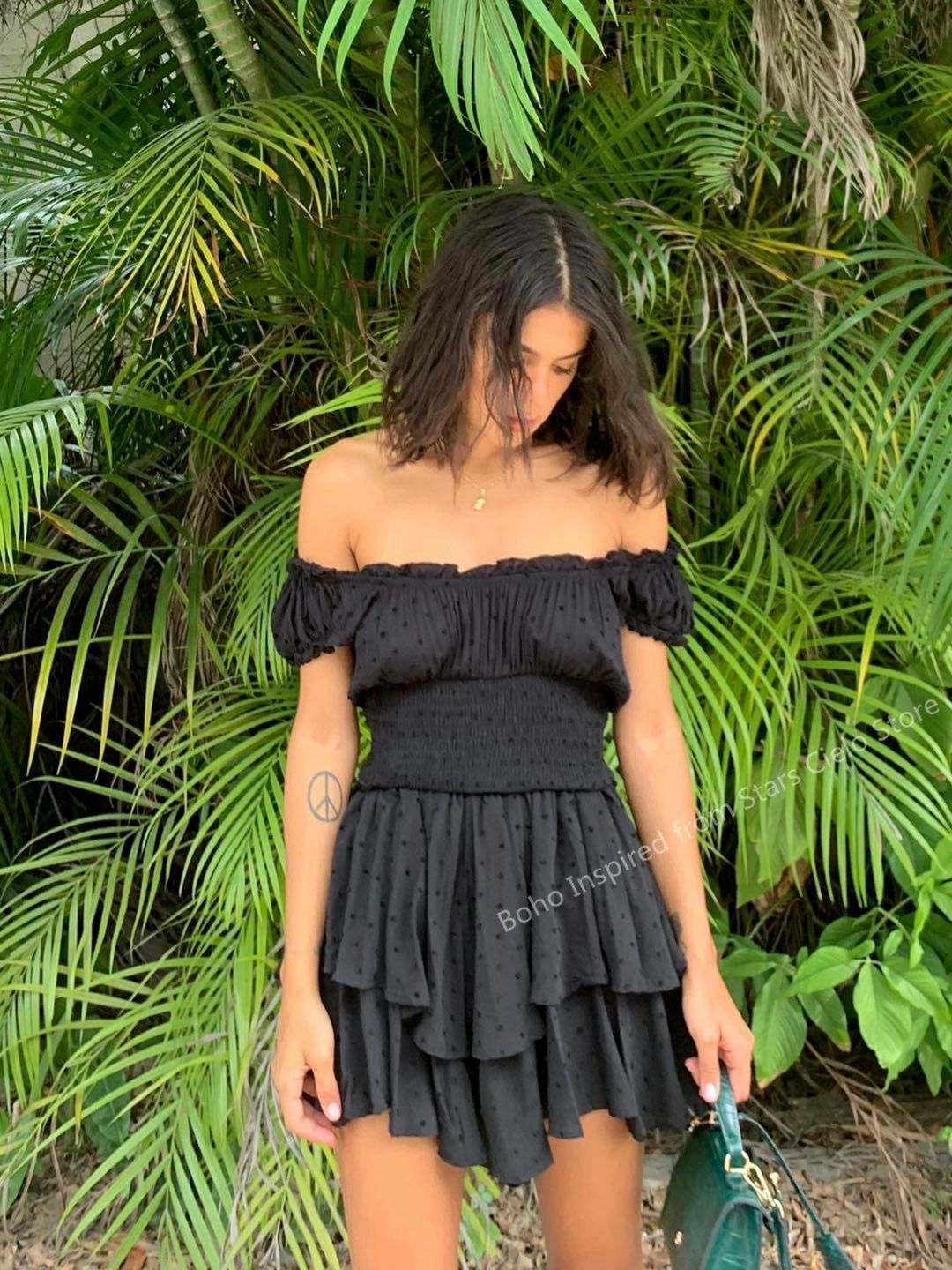 Boho-inspired mini summer dress with shirred ruffled neckline, tiered design, puff sleeves, and rayon fabric by The Clothing Company Sydney.