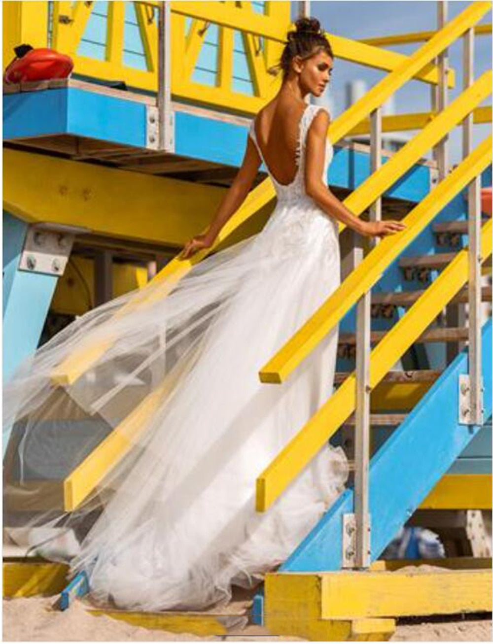 Plus size boho beach wedding dress with V-neck, lace appliques, and backless design by The Clothing Company Sydney.