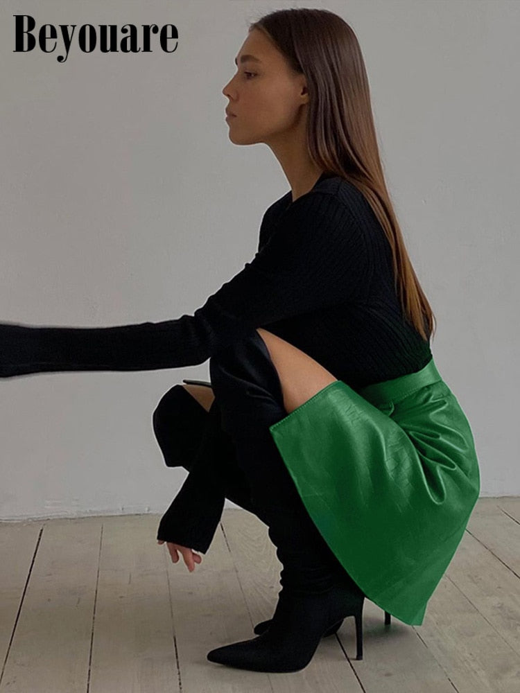 Elegant green faux leather crocodile pattern A-line skirt with high waist and split mini design from The Clothing Company Sydney.