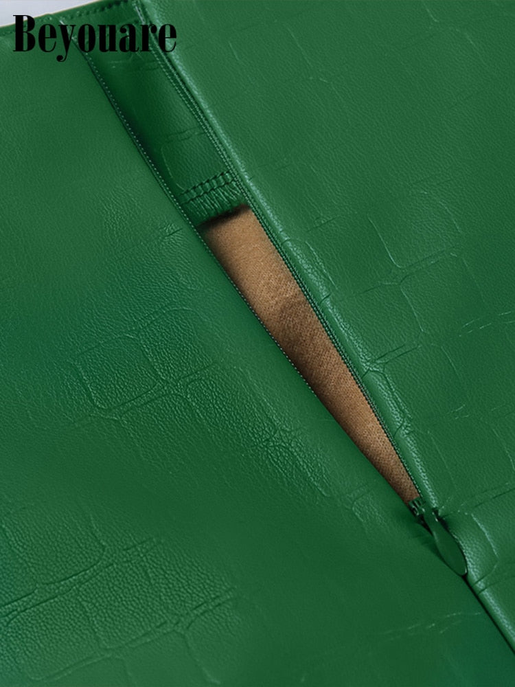 Elegant green faux leather crocodile pattern A-line high waist mini skirt with split detail by The Clothing Company Sydney.