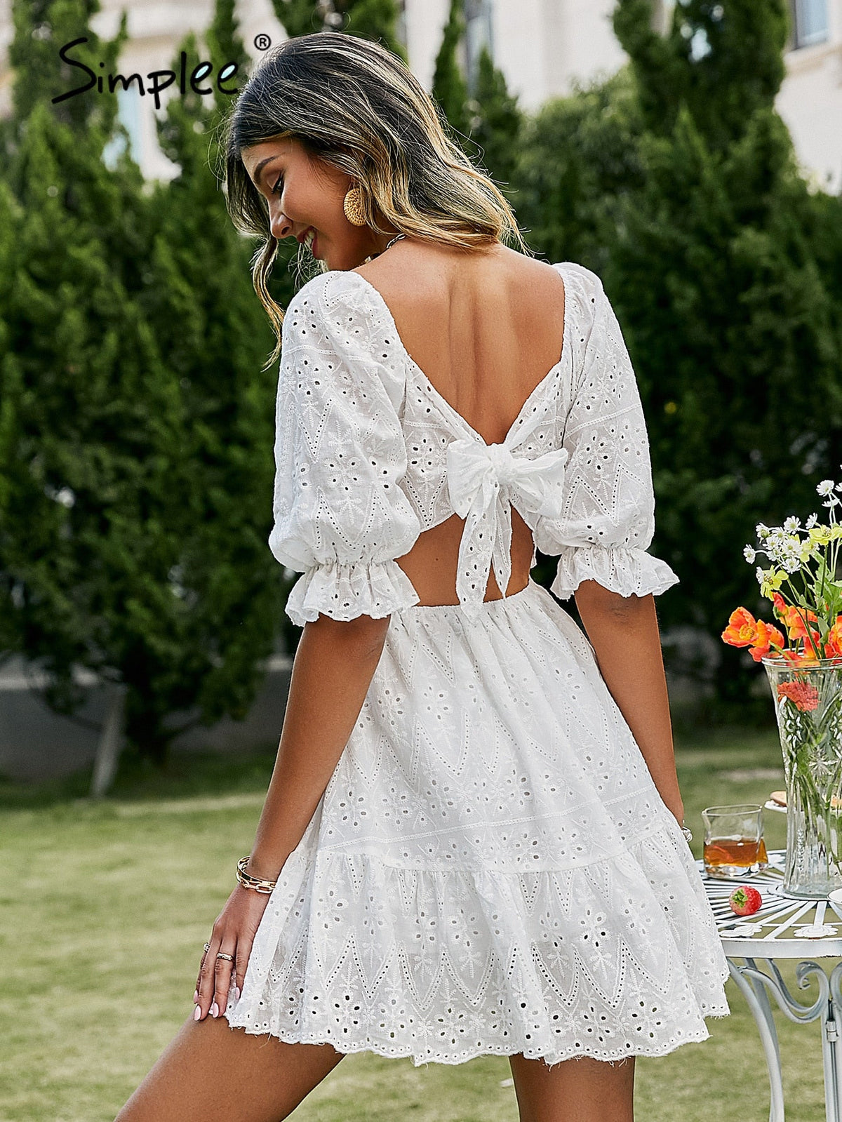 White cotton summer dress with lace-up front, hollow out design, high waist, ruffles, and A-line silhouette by The Clothing Company Sydney
