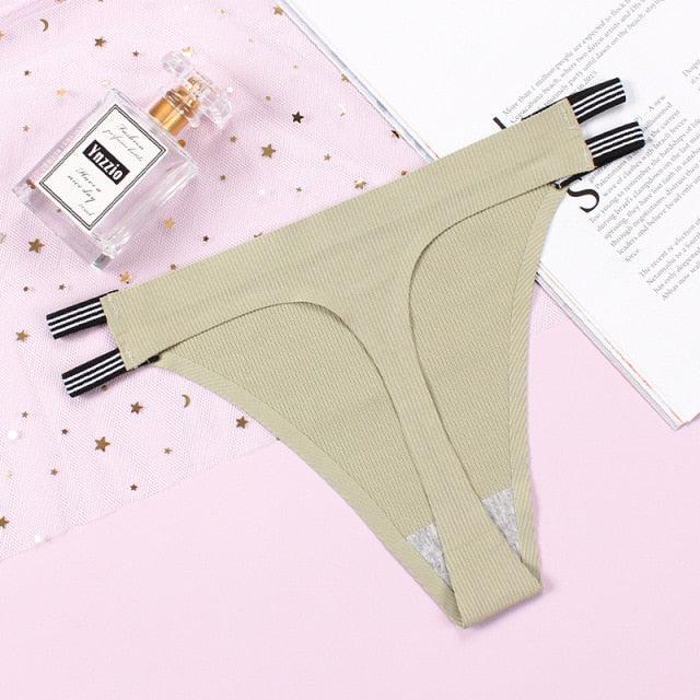 Two seamless thong panties from The Clothing Company Sydney, featuring lacy, lightweight g-string underwear in a black and nude color.