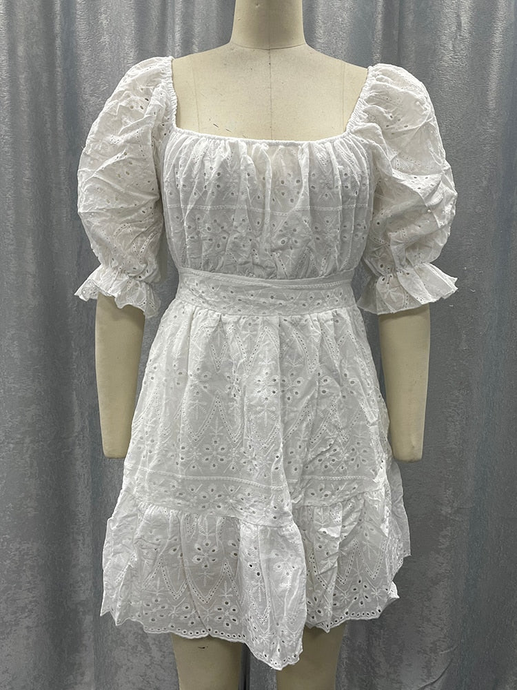 White cotton summer dress with lace-up front, hollow-out design, high waist, ruffles, and A-line frills by The Clothing Company Sydney.