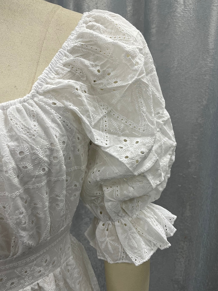 White cotton A-line summer dress with lace-up front, ruffles, hollow-out design, high waist, and frills from The Clothing Company Sydney.
