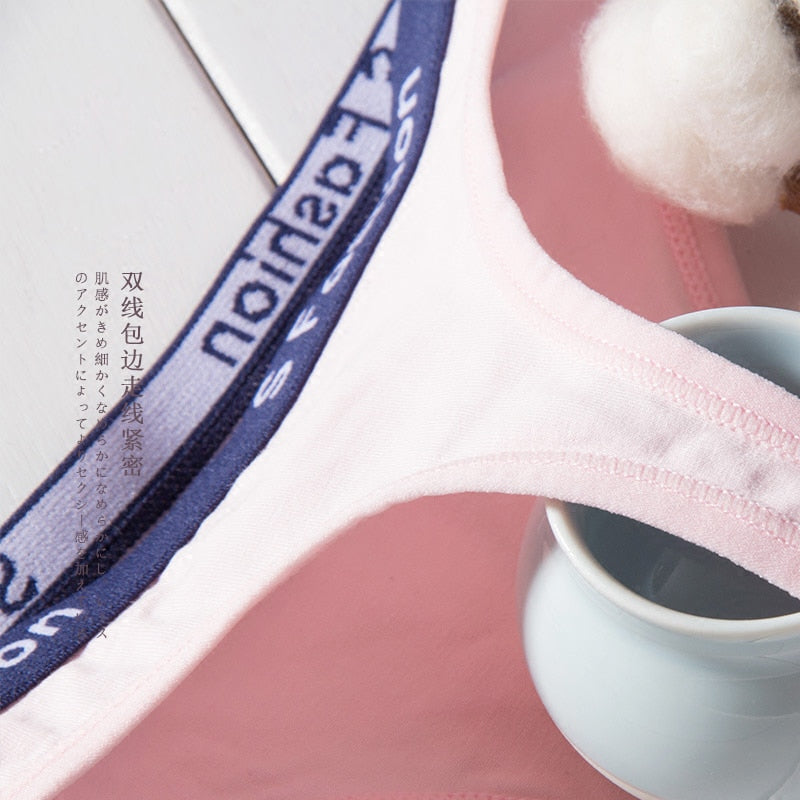 Three-pack of The Clothing Company Sydney cotton mix G-string panties featuring seamless T-back, low-rise waist, and transparent briefs.