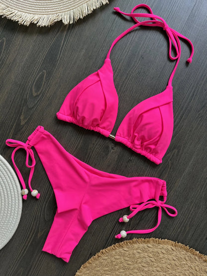Two-piece pink micro bikini set for women with triangle tops and matching bottoms, perfect for beachwear and swimming.
