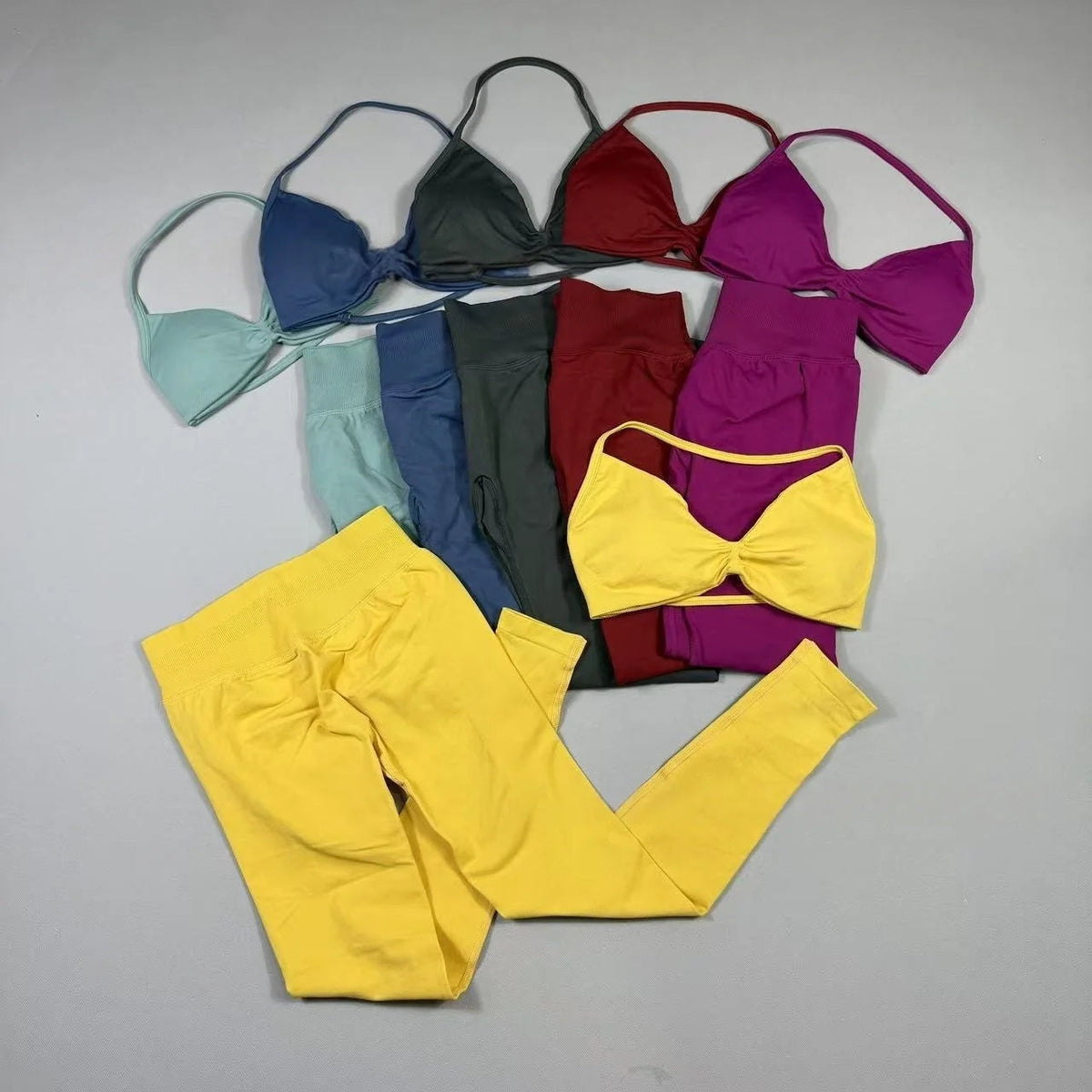Women's seamless yoga set with halter neck sports bra and high-waisted lifting leggings on model