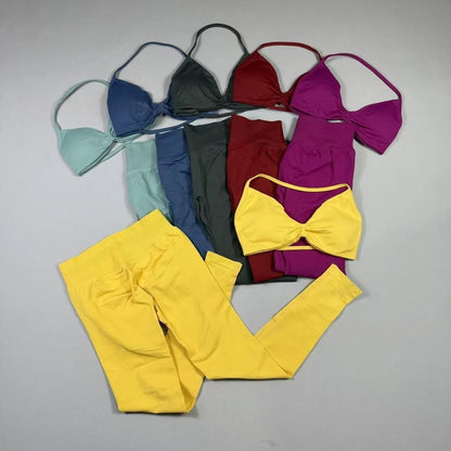 Women's seamless yoga set with halter neck sports bra and high-waisted lifting leggings on model