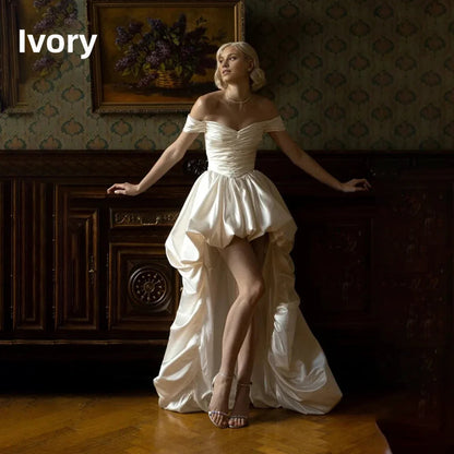 Satin off-shoulder bridal gown with ruched bodice, lace-up back, short front and long train wedding dress