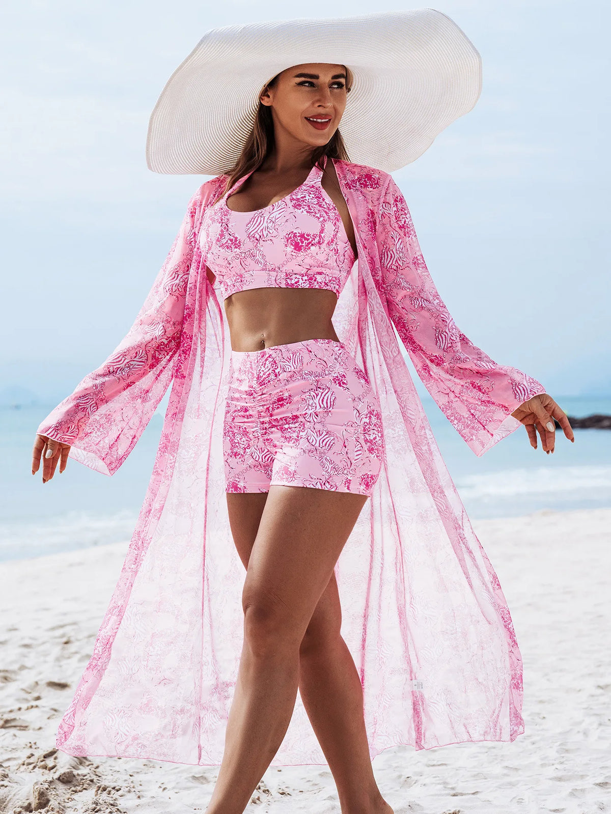 Women's three-piece summer tankini swimsuit with push-up top and matching swim bottoms and cover-up piece