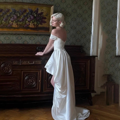 Satin off-shoulder bridal wedding dress with ruched bodice, lace-up back, short front and long train