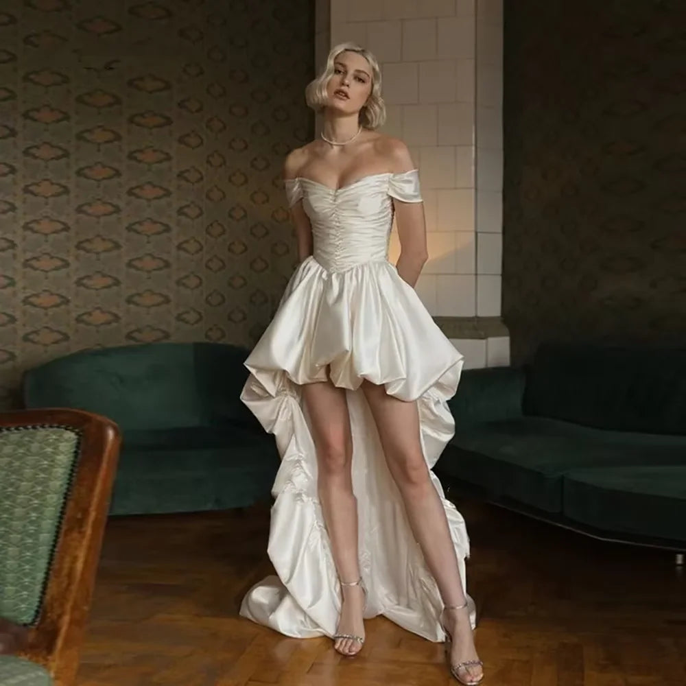 Satin off-shoulder bridal wedding dress with ruched bodice, lace-up back, short front and long train