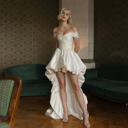 Satin off-shoulder bridal wedding dress with ruched bodice, lace-up back, short front and long train