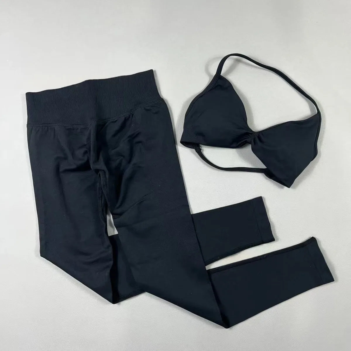 Women's seamless yoga set with halter neck sports bra and high-waisted lifting leggings for workouts