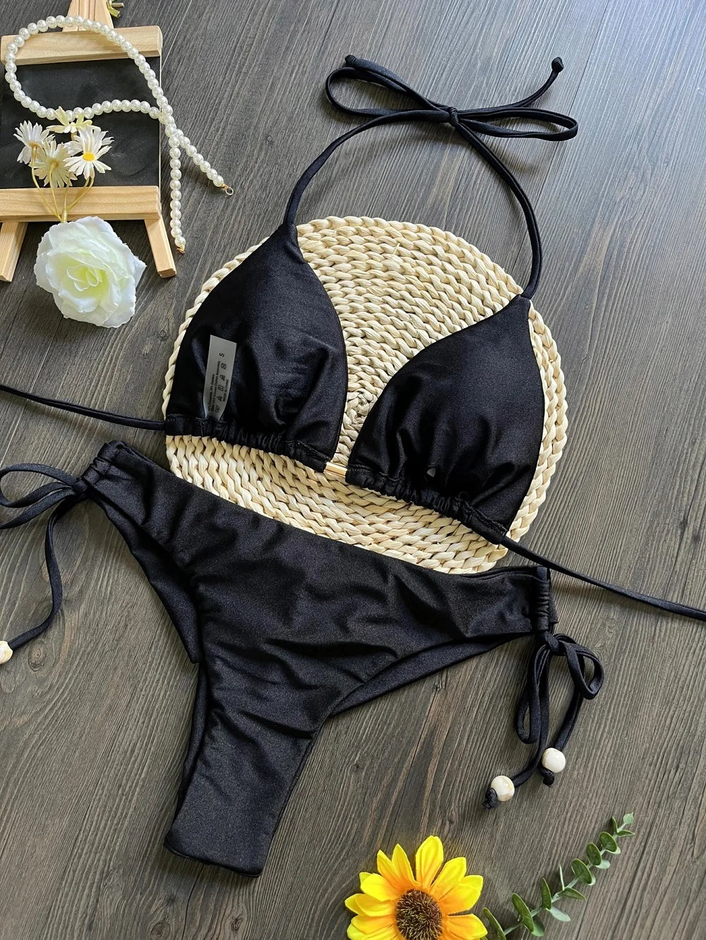 Two-piece micro bikini set by The Clothing Company Sydney featuring triangle swimwear in vibrant colors on a beach background.